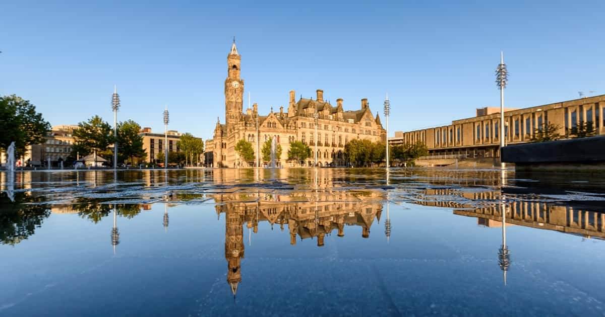 Photograph of City Park in Bradford with the town hall reflected in the water