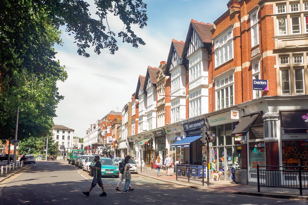 Shops on a high street in Ealing on a sunny day