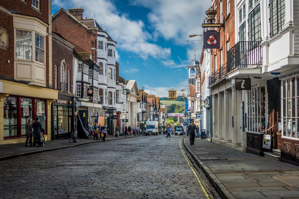 Pedestrians passing shops on Guildford High Street, Surrey