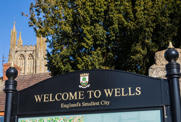 Sign reading Welcome to Wells, England's Smallest City
