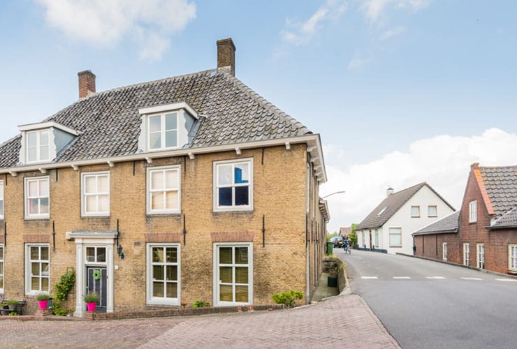 An historic house with a hip roof.
