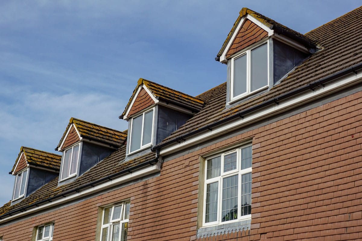 A residential building with hip roof dormer windows.